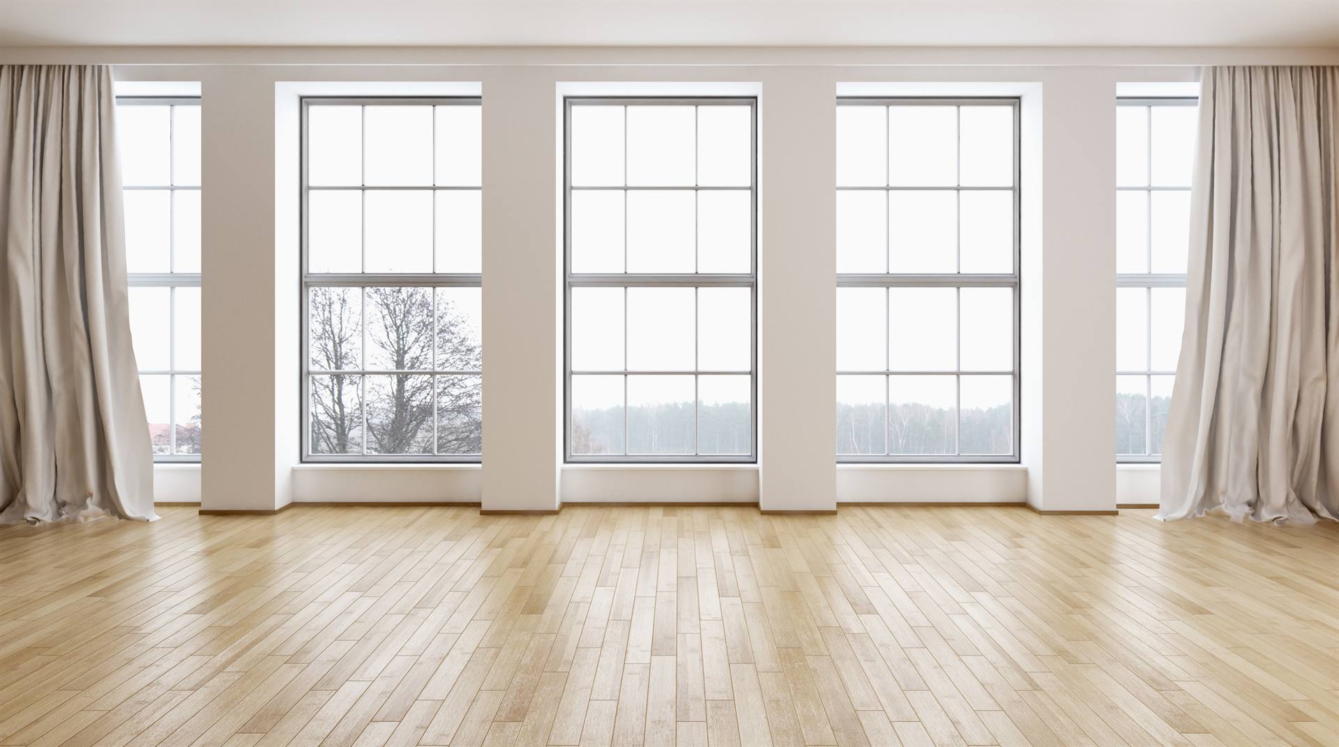 Sunlit room lined with tall replacement windows