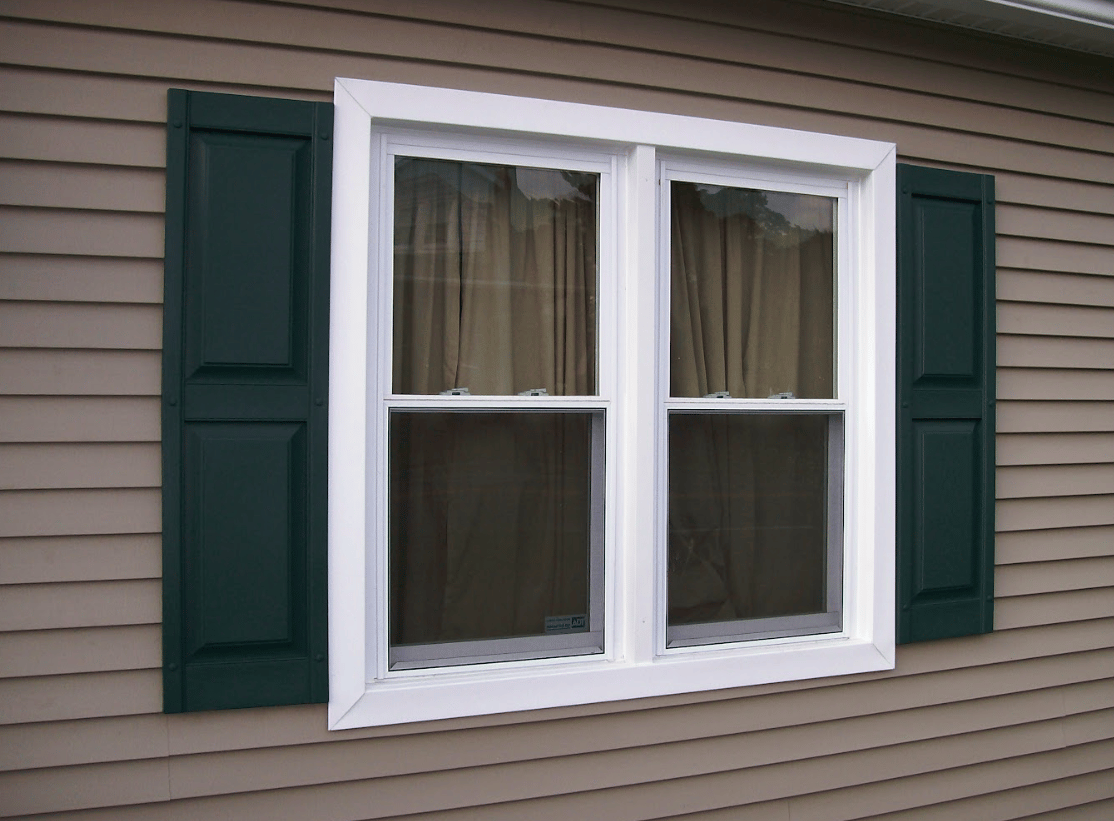 exterior oriel windows with black shutters