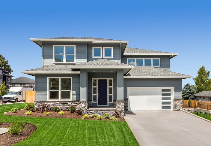 Two-story gray home with white-trimmed picture and double-hung windows across both floors